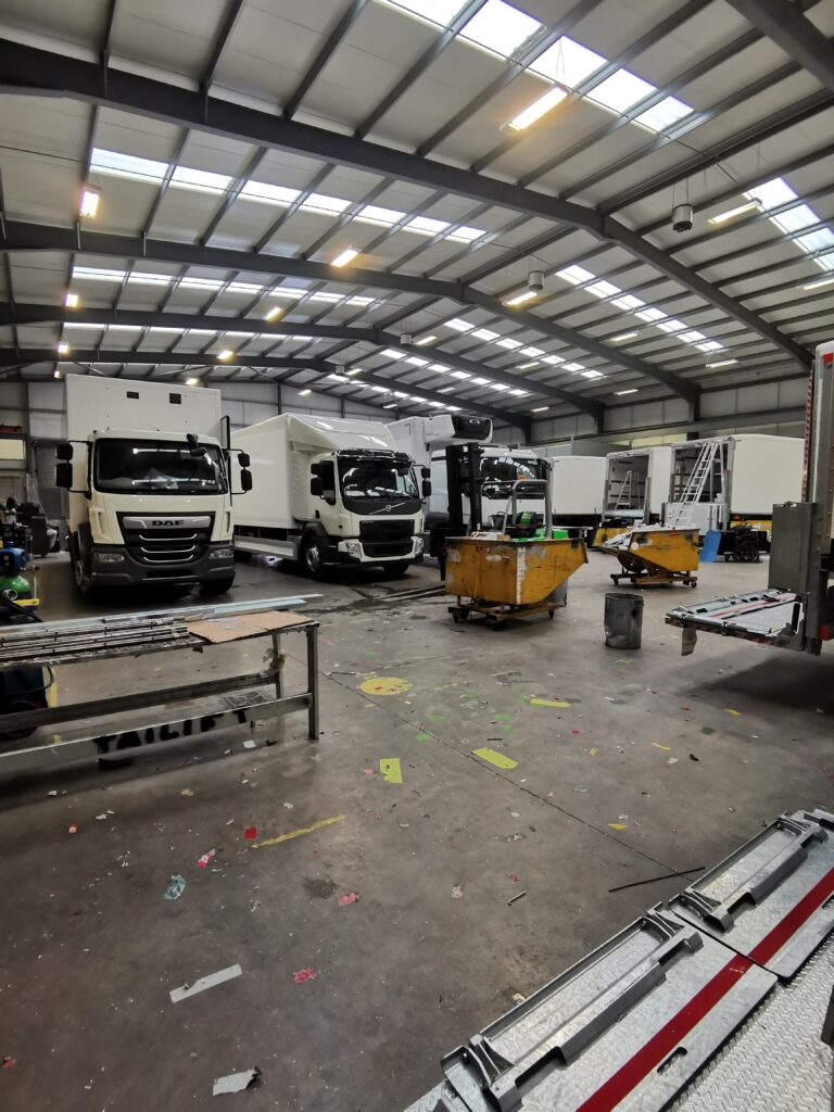 Commercial vehicles in workshop for fleet electrical installations